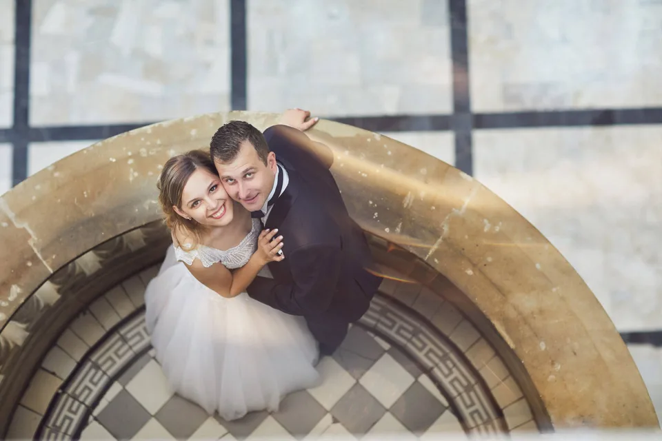 Para młoda sfotografowana z góry przy okrągłych schodach